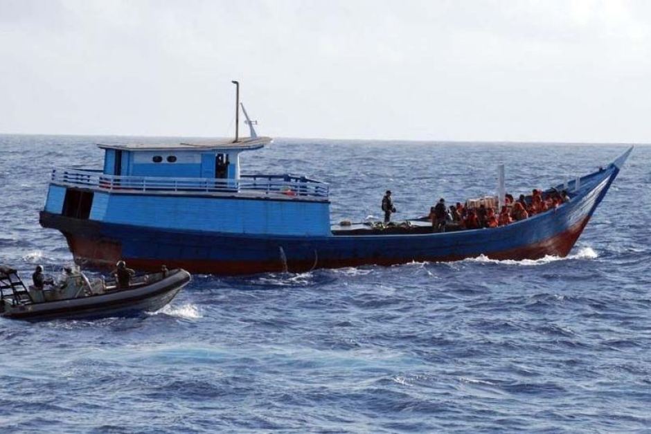 The Australian Navy intercepts a boat carrying asylum seekers north of Australia