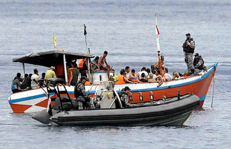The Australian Navy intercepts a boat carrying asylum seekers north of Australia
